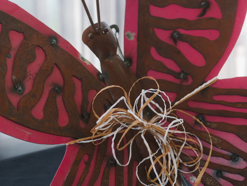 Photo of pink and bronze decorative butterfly sculpture