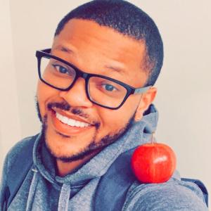 Photo of author Antwan Eady with an apple on his shoulder